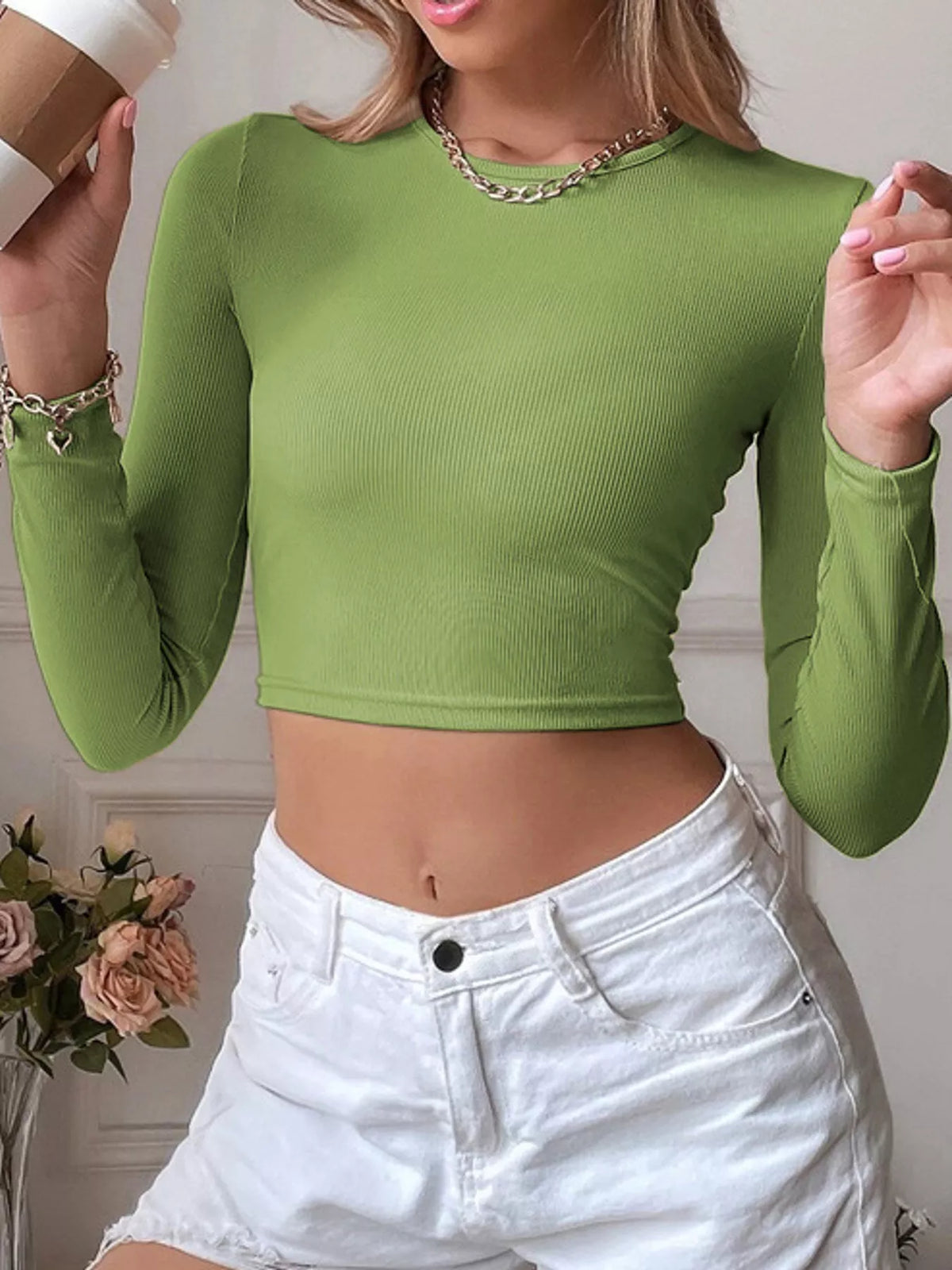 Close front view of the green ribbed crop top and crew neckline