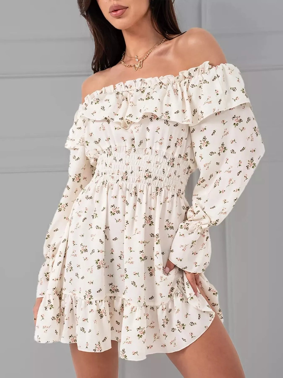 Side view of the white floral off-shoulder dress with elastic smocking and tiered ruffle hem.