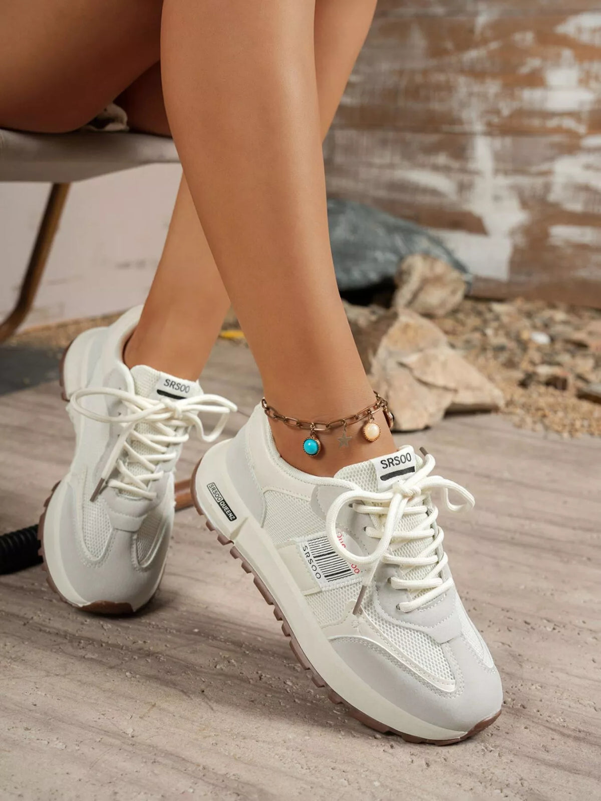 Gray lace-up sneakers worn with shorts