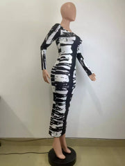 Angled mannequin view of black and white fitted tie-dye maxi dress