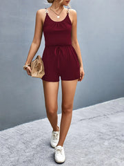 Full-length burgundy romper styled with sneakers