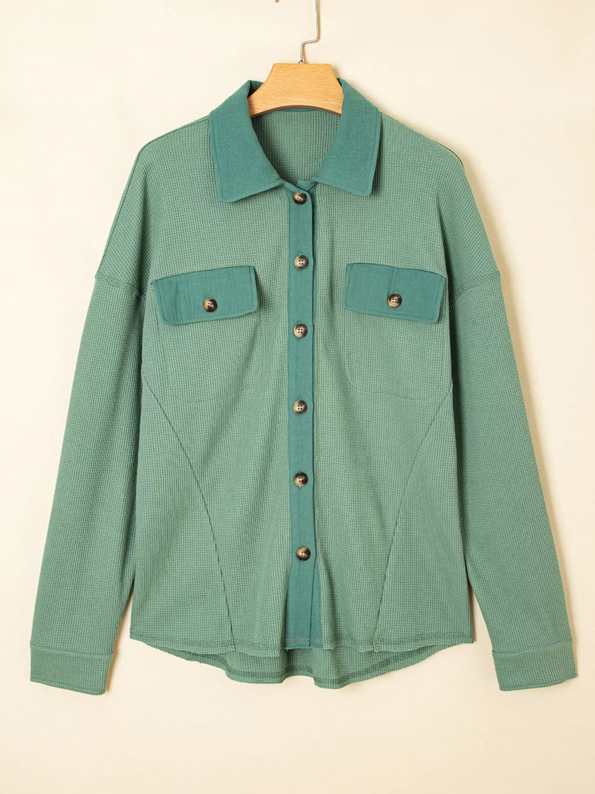 Front view of sage waffle-knit shirt on hanger