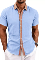 Model wearing light blue shirt with patterned rust collar and placket