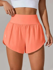 Front view of coral running shorts with curved hems and wide waistband