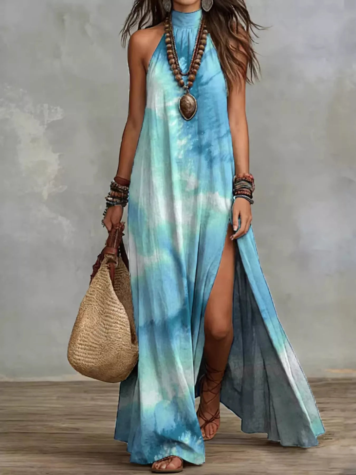 Women's sleeveless maxi dress in a turquoise and pale blue tie-dye print, shown full length.