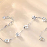 Close-up of circular and rectangular details along the silver chain bracelet