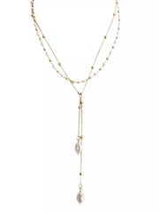 Gold-tone layered pearl necklace with two long drops shown on a white background