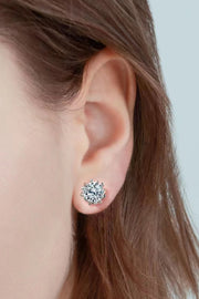 Close-up of a round clear-stone stud earring worn on an ear