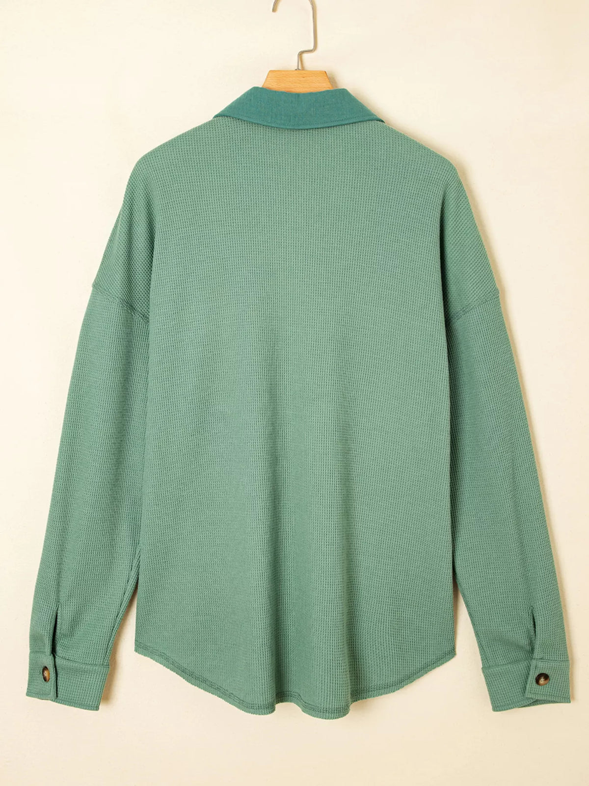 Back view of sage shirt showing relaxed hem