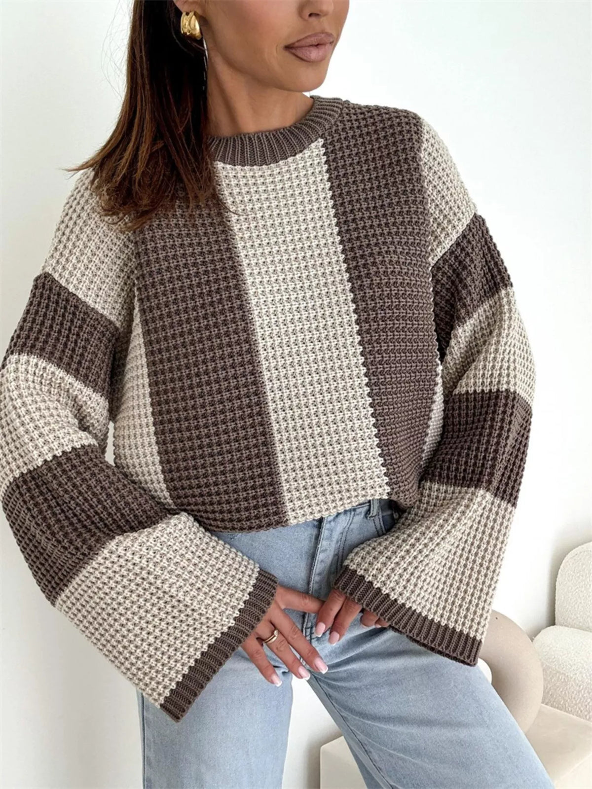 Front view of cream and taupe sweater showing broad stripes and flared sleeves