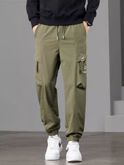 Front view of olive cargo joggers with drawstring waist and flap thigh pockets.