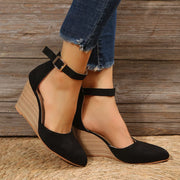 Black pointed-toe wedge sandals shown together from the front