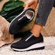 Underside and side view of black knit wedge sneaker with white sole