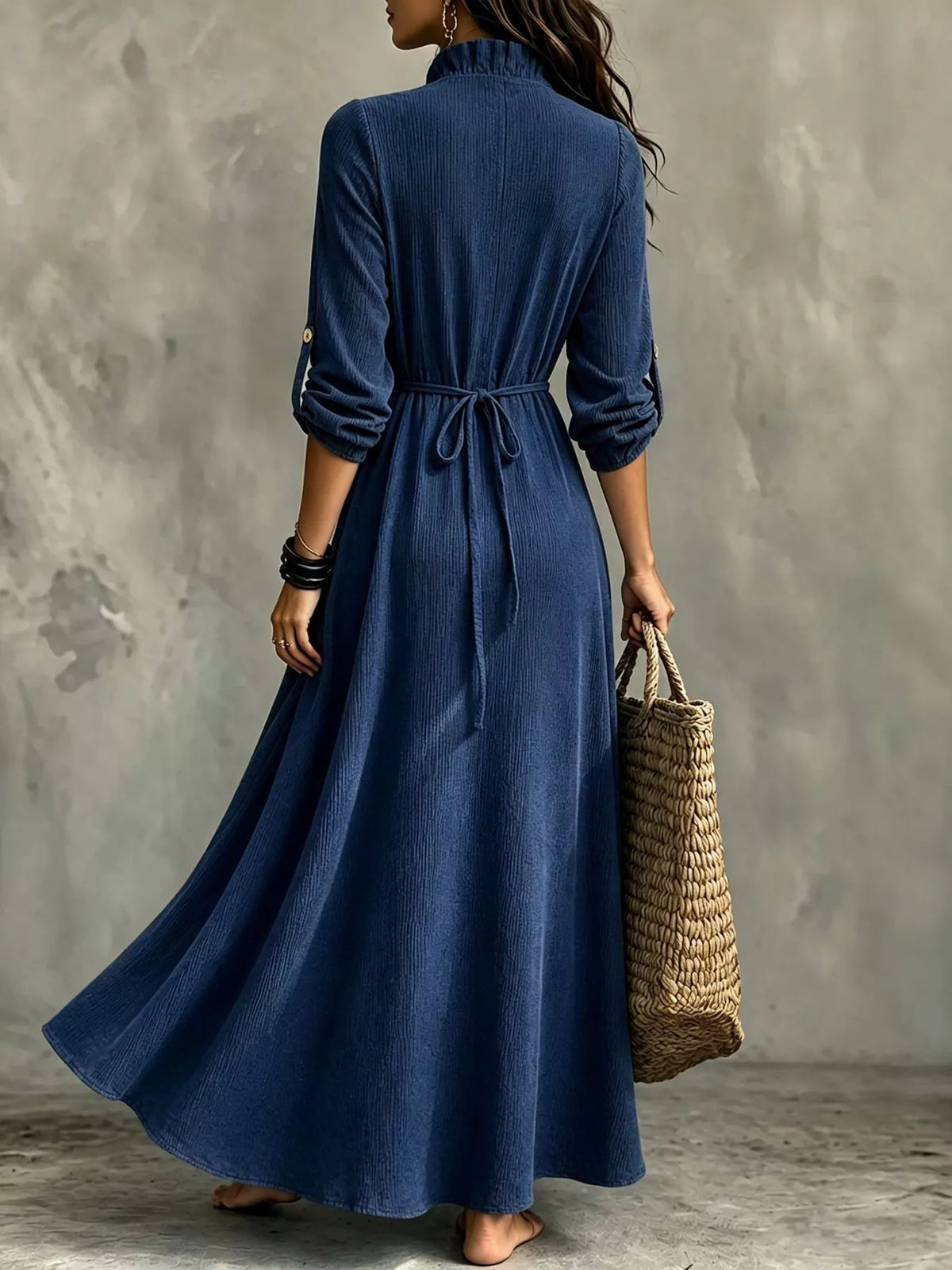 Back view of navy maxi dress showing waist tie and flowing skirt