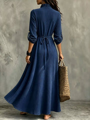 Back view of navy maxi dress showing waist tie and flowing skirt