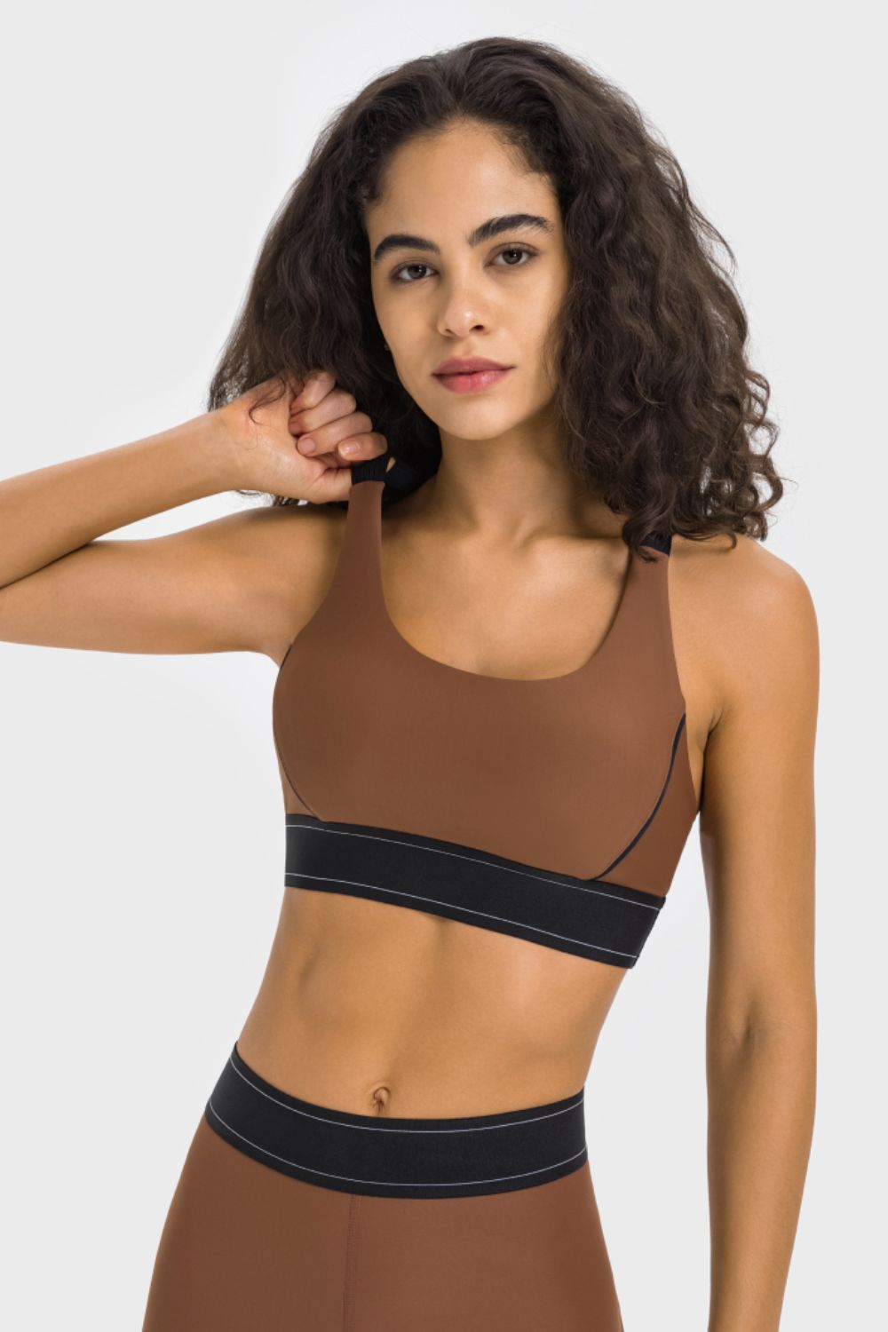 Front view of brown contrast sports bra with black piping