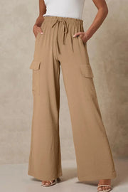 Front view of tan drawstring utility trousers with roomy legs
