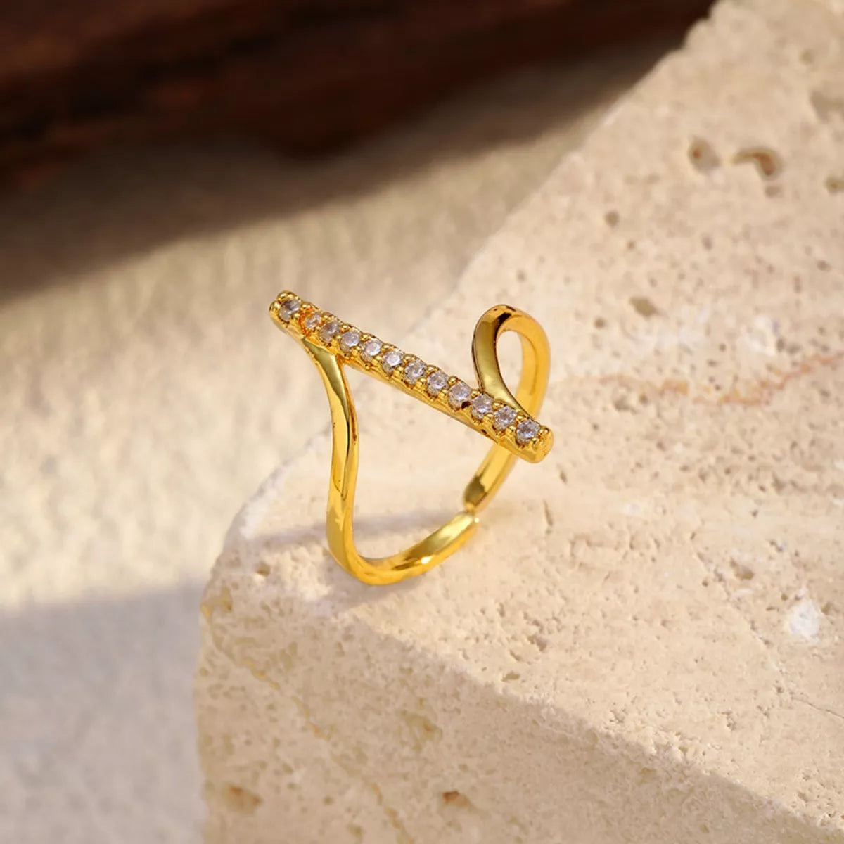 Gold-tone irregular open ring with rhinestone-set diagonal bars