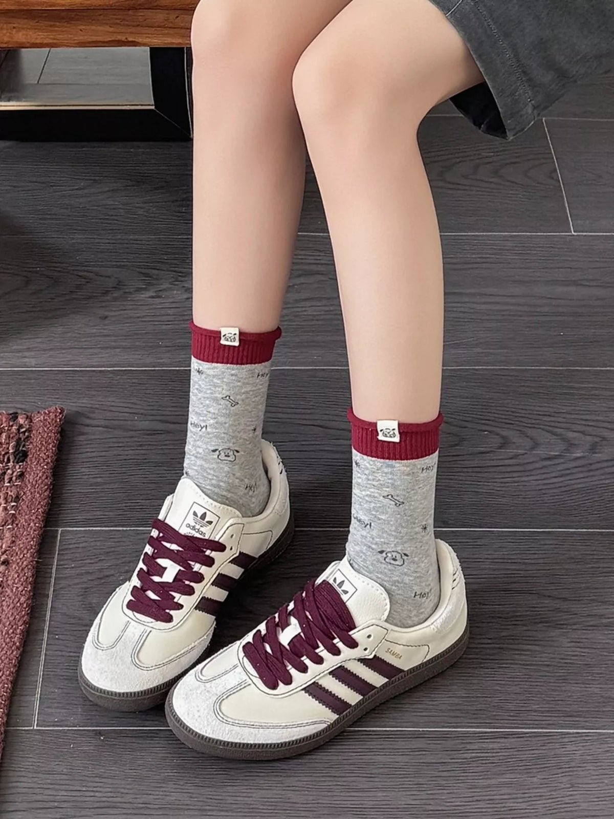 Model wearing gray printed crew socks with sneakers