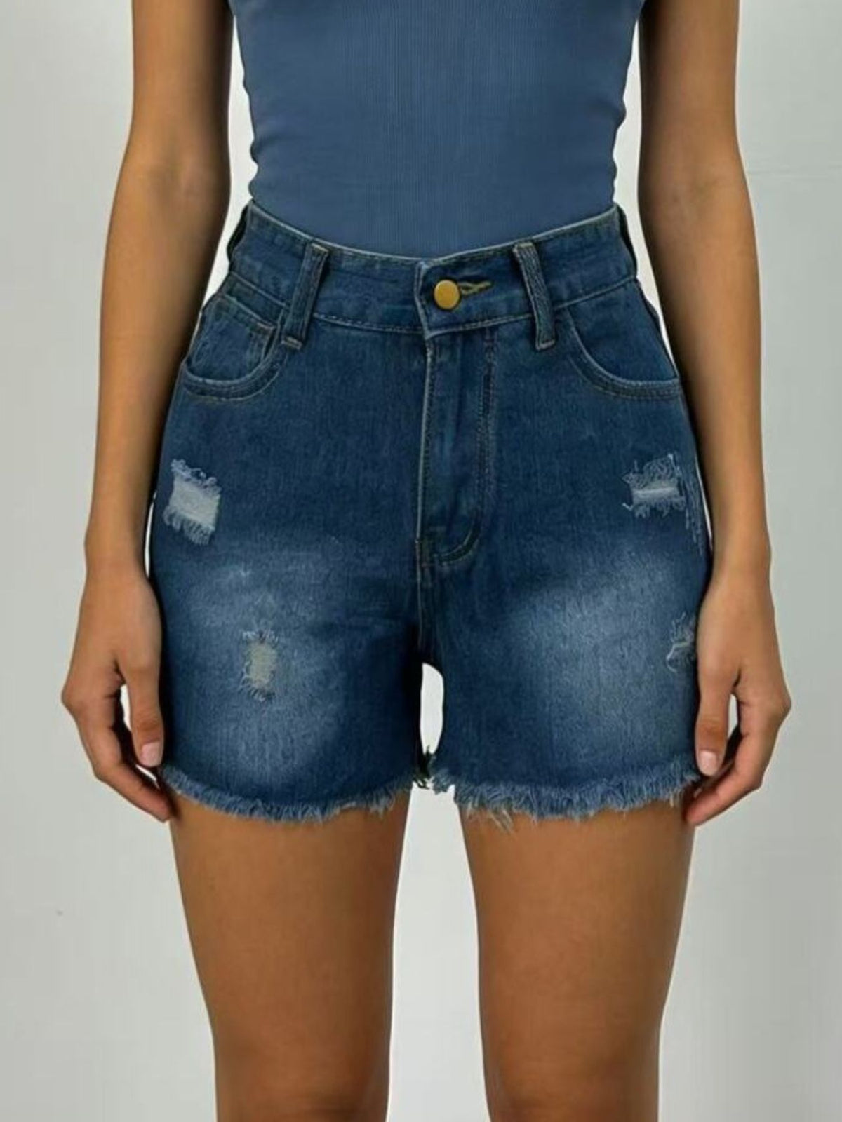 Side view of dark-wash distressed denim shorts