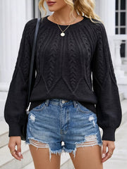 Close view of the black cable-knit sweater with a shoulder bag strap