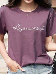 Model wearing a purple crew-neck T-shirt with embroidered script lettering