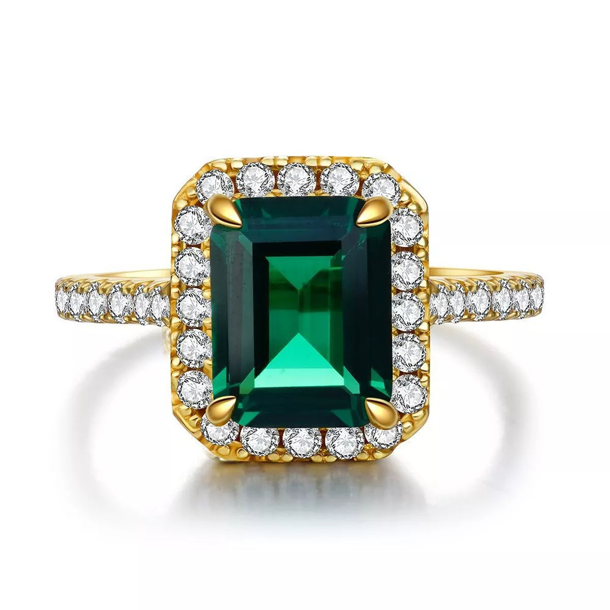 Front view of the green rectangular center stone and clear halo on a gold-tone band.