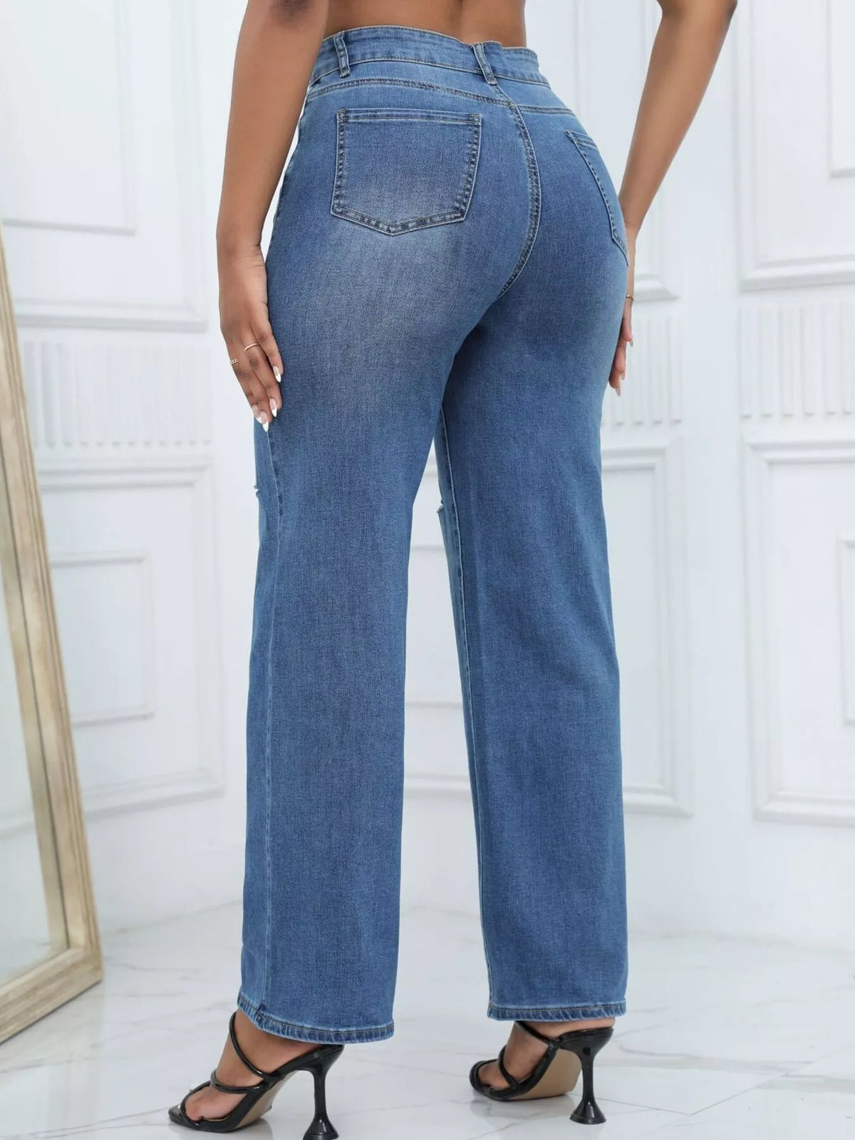 Rear three-quarter view of medium-blue wide-leg jeans