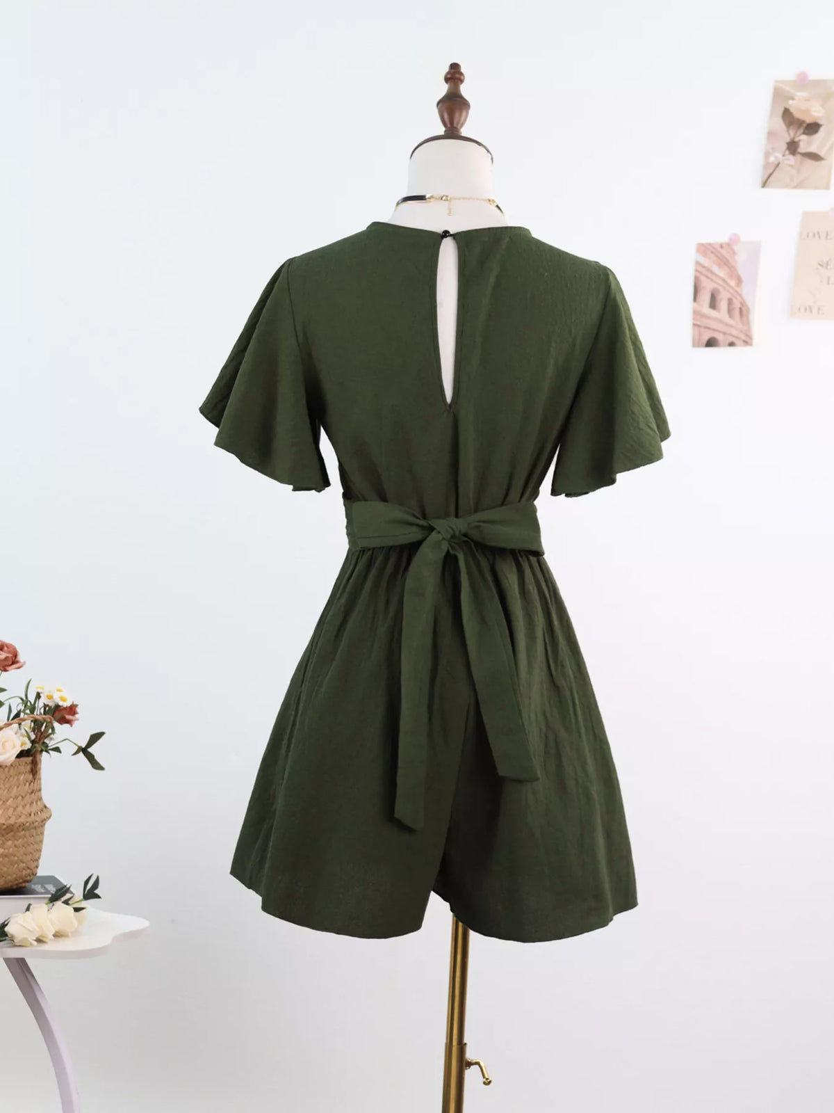 Back view of olive romper with waist tie