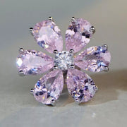 Close view of pink flower stud earring showing six faceted petals and clear centre