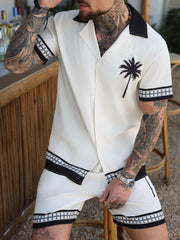 Close view of black collar and palm-tree graphic on orange shirt