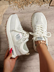 White lace-up sneakers shown from above