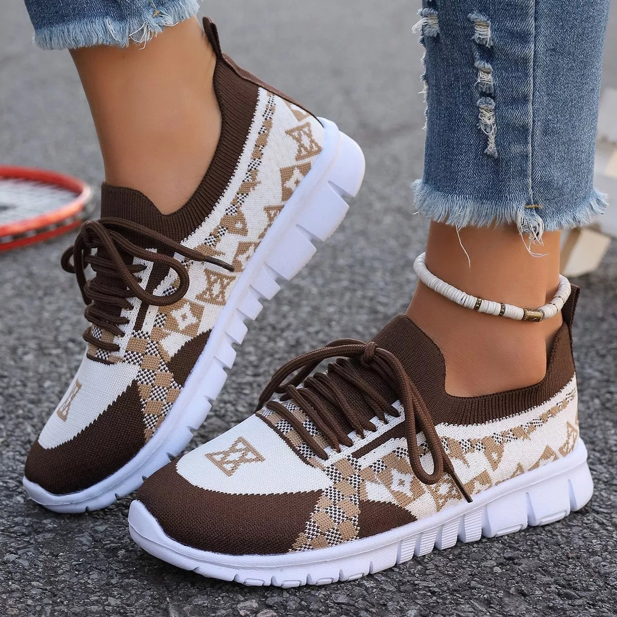 Brown and cream mesh sneaker with dark brown laces, worn with jeans