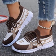 Brown and cream mesh sneaker with dark brown laces, worn with jeans