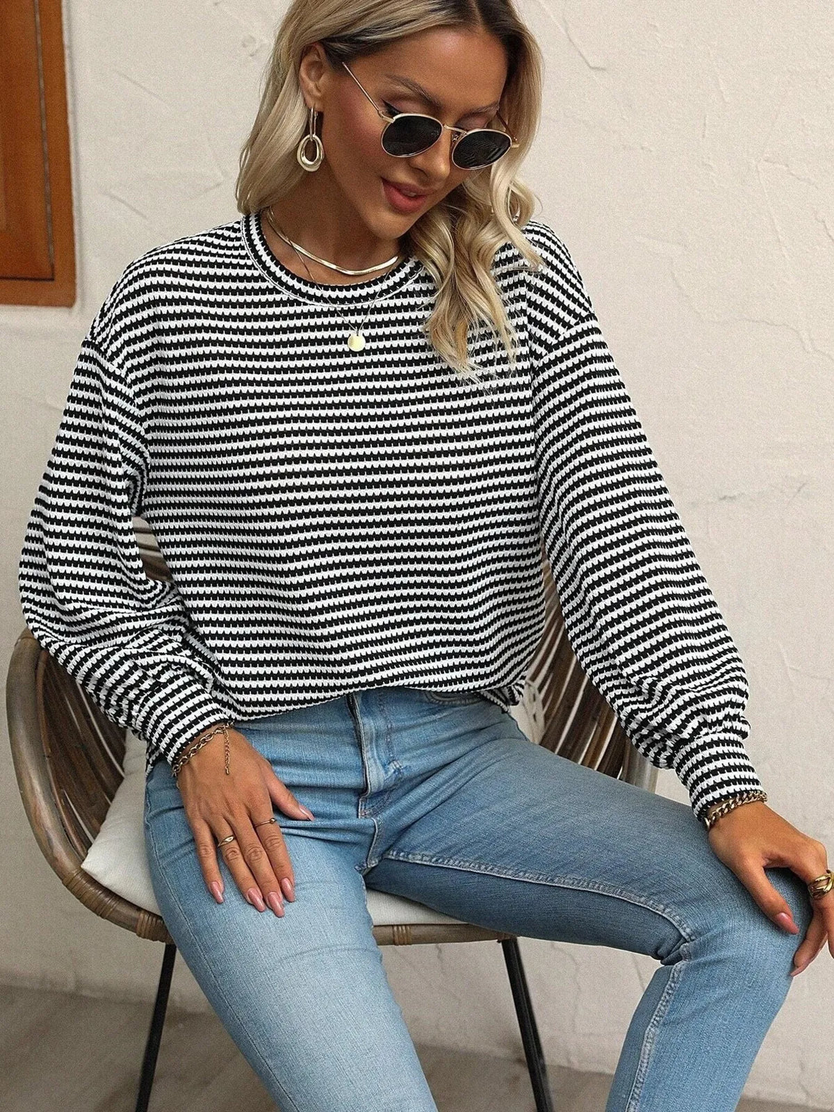 Striped lantern-sleeve top shown while seated
