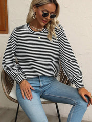 Striped lantern-sleeve top shown while seated