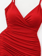 Detail of the red dress's overlapping V-neck bodice and gathered fabric.