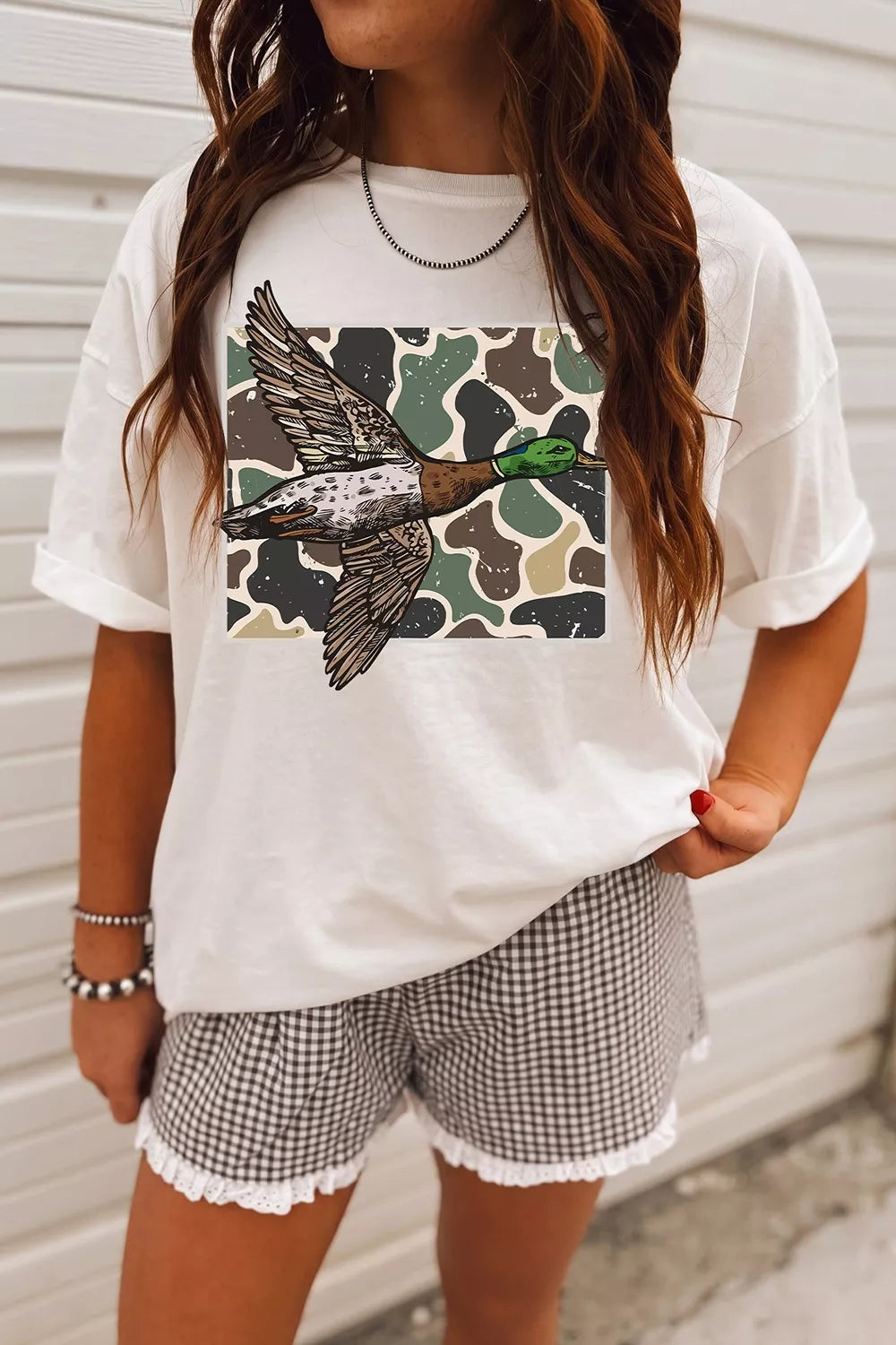 Front view of duck graphic tee styled with patterned shorts