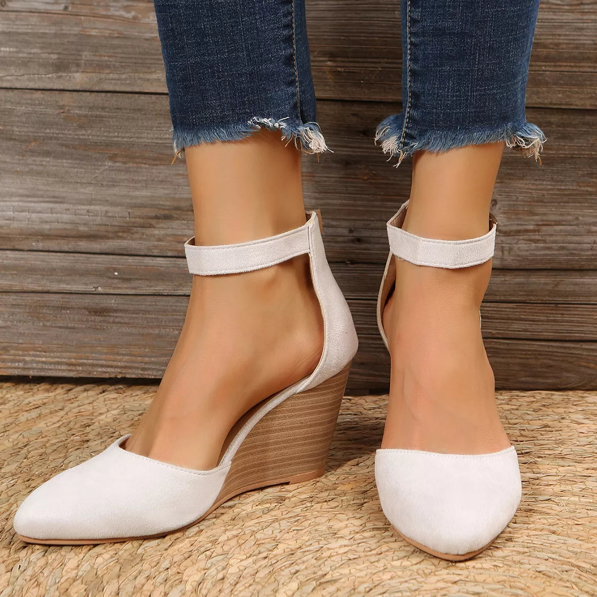 White wedge sandals shown from the front with ankle straps