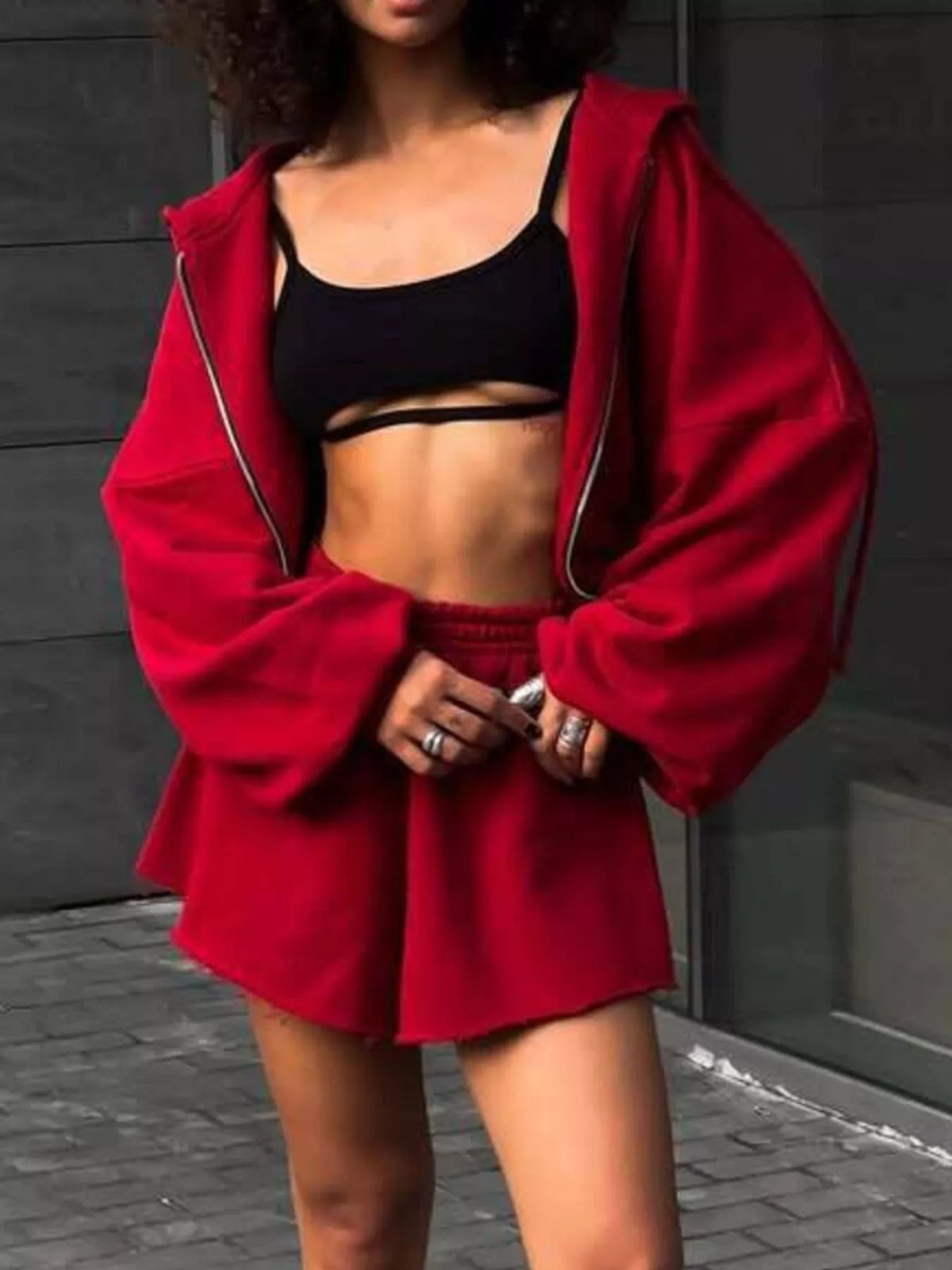 Front view of red hoodie and shorts with black top