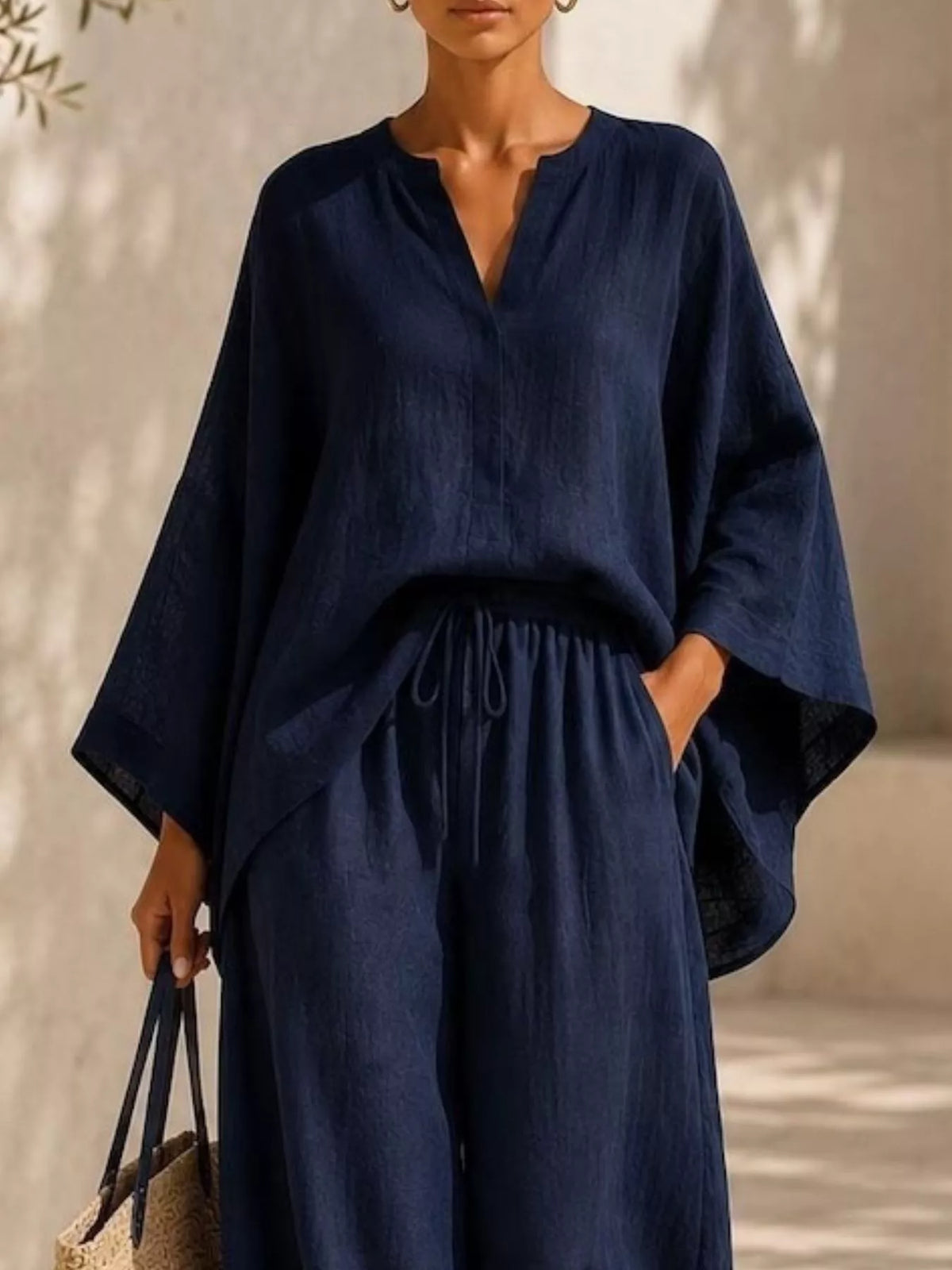 Closer front view of the navy set highlighting the loose sleeves and tied waist.