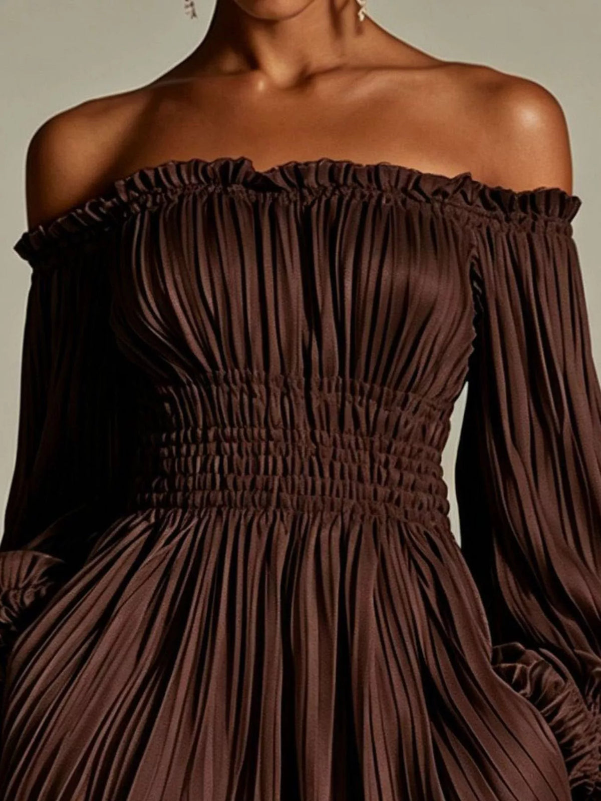 Model wearing the dark brown dress with off-shoulder neckline and full sleeves