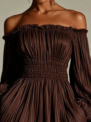 Model wearing the dark brown dress with off-shoulder neckline and full sleeves