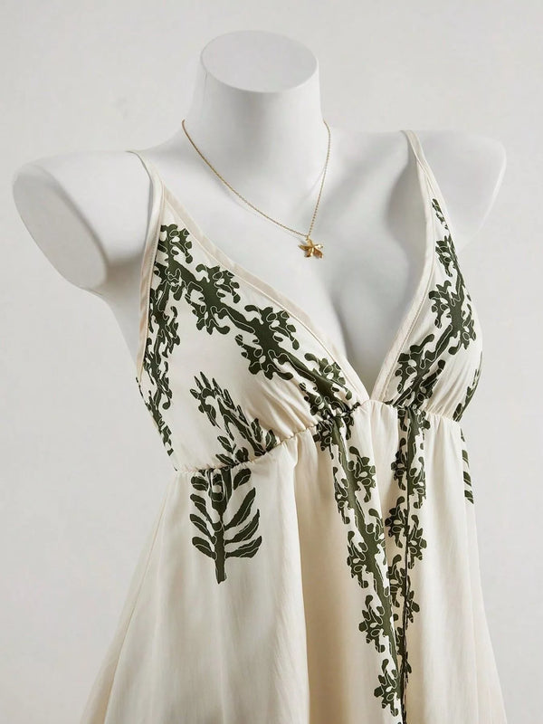 Close view of ivory V-neckline and dark embroidered floral vines on the bodice