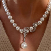 Close-up of pearl strand and ornate zircon centerpiece with drop pearl
