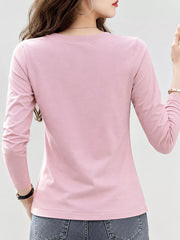 Back view of a pink long-sleeve T-shirt worn with jeans.