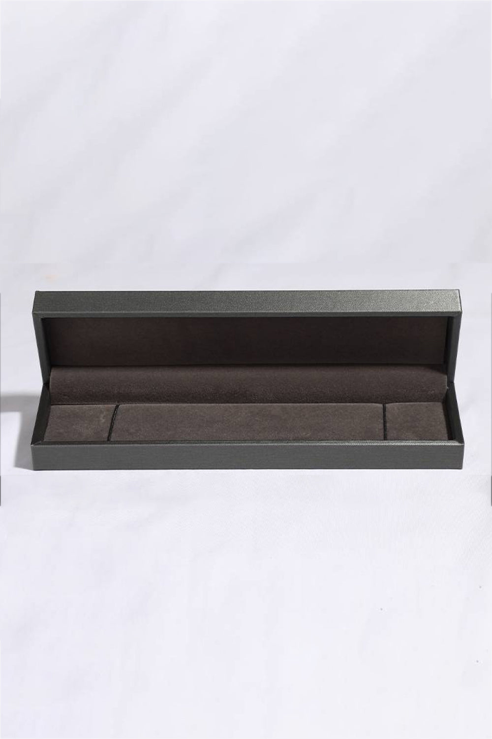 Silver bracelet displayed in an open dark presentation box.