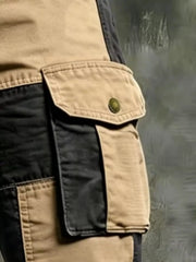 Close-up of tan cargo pocket with snap button and black contrast panels