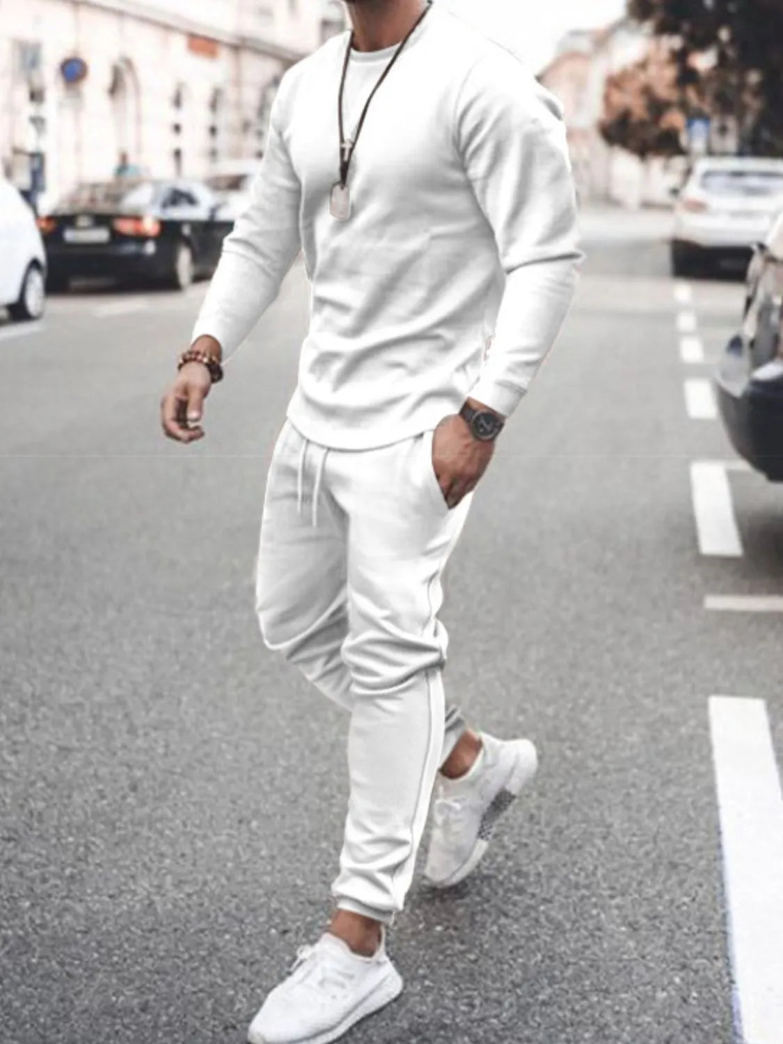 Model wearing white long-sleeve top and jogger pants set