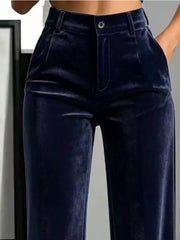 Close front detail of navy velvet pants showing button waist and front pockets